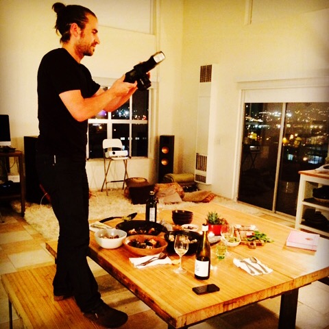 Eric Wolfinger taking a picture of the fish stew he made, pre-interview. Photo by Cari Borja