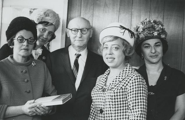 Isaac Bashevis Singer, flanked by muses.