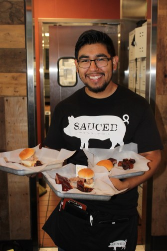 Sauced's Tony Leon with ribs, burnt ends and sliders. Credit: Geneva Anderson.