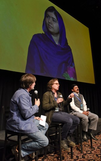 Directors Ken Burns and Davis Guggenheim, Ziauddin Yousafzai and his daughter Malala (via telecast) speak at a screening of He Named Me Malala; (Photo: Vivien Killilea, gettyimages)