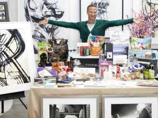 Lash Fary with some of the 2014 Unofficial Oscar Goodie Bag goodies his team assembled. –Photo courtesy of Business Week