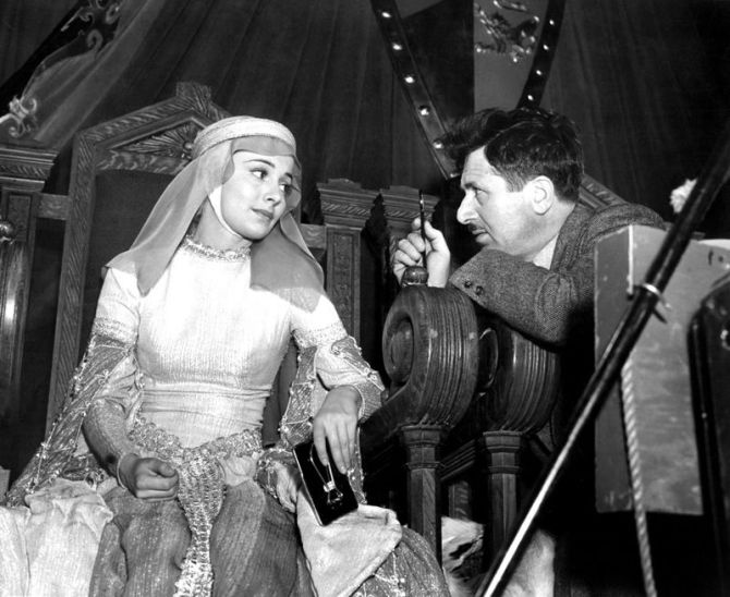 OLIVIA DE HAVILLAND is given some last minute lighting by cameraman SOL POLITO for ADVENTURES OF ROB